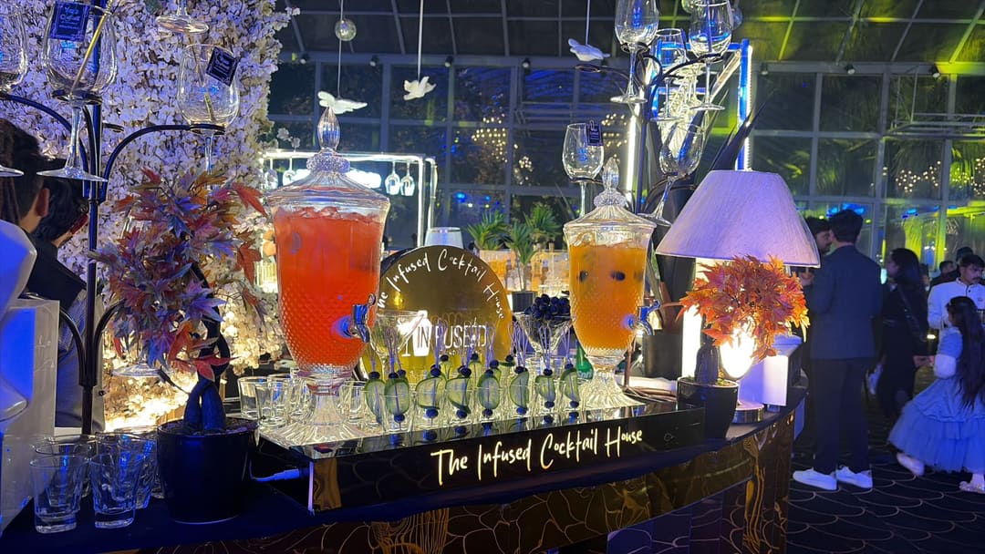 Bartenders serving guests at an event bar